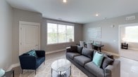 This well-designed two-bedroom, two-bathroom residence is laid out entirely on a single floor, offering a practical and cohesive living experience. The open-concept living and dining area serves as the heart of the home, featuring recessed lighting, neutral gray walls, and large windows that allow generous natural light and outdoor views to fill the space. Light hardwood-style flooring runs through the main living areas, contributing to the clean, contemporary aesthetic.

The kitchen is thoughtfully appointed with white shaker cabinetry, granite countertops, a subway tile backsplash, stainless steel appliances including a range with a sleek hood vent, built-in microwave, and a full-size refrigerator. A kitchen island with a double sink provides additional prep space and casual seating.

Both bedrooms feature soft carpeting, ample natural light from windows with blinds, and neutral wall tones. One bedroom includes a walk-in closet with built-in shelving, enhancing storage capacity. The two bathrooms are finished with white vanity cabinetry, marble-style countertops, and recessed lighting. One bathroom offers a tub-shower combination, while the other features a more compact layout. Together, the rooms create a cohesive, move-in-ready living environment.