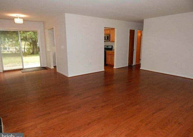 home layout: living/dining L that surrounds kitchen. Hallway leads to bedrooms - 6916 Crafton Ln