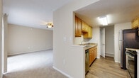 Located at 999 San Marco Dr in Largo, Florida, this single-floor unit presents a well-organized layout designed for everyday comfort and functionality. The interior is finished in neutral, warm tones throughout, creating a cohesive and inviting atmosphere across all rooms.

The galley-style kitchen is a standout feature, lined on both sides with honey-toned wood cabinetry that provides ample storage. Granite-look countertops, a stainless steel dishwasher, a black refrigerator, and an electric range complete the space, while wood-look flooring adds a clean, durable finish. The kitchen opens toward the living area, which flows seamlessly through the unit and is finished with plush neutral carpeting and a ceiling fan with light fixture.

The bedrooms are carpeted and bright, each equipped with ceiling fans. One bedroom features a window with blinds, allowing natural light to filter in. The living and dining areas extend the open feel of the space, with soft overhead lighting enhancing the warm ambiance.

The bathrooms feature wood-look flooring, warm cabinetry with granite-look countertops, and a tub/shower combination. A dedicated laundry area houses a full-size top-load washer and dryer, adding significant convenience to daily living.