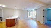 Located at 1935 Addison St in the heart of Berkeley, CA, this 2-bedroom, 1-bathroom residence offers a well-designed, single-floor layout that maximizes functionality and comfort. The open-concept living and kitchen area is anchored by warm bamboo hardwood flooring that extends throughout the main space, creating a bright and cohesive environment. Large corner windows in the living area invite abundant natural light and provide views of the surrounding neighborhood.

The kitchen is thoughtfully equipped with rich warm-toned cabinetry, a central island with a white countertop and integrated sink, and a full suite of stainless steel appliances including a refrigerator, electric range, and microwave. Track lighting and recessed fixtures illuminate both the kitchen and living areas effectively.

The spacious primary bedroom features plush carpeting, a window with neighborhood views, and a mirrored sliding-door closet offering ample storage. The second bedroom is similarly carpeted and includes its own window and mirrored closet. The shared full bathroom is finished with light tile flooring, warm wood cabinetry, a white countertop vanity, and a tub-shower combo accented by a decorative mosaic tile border. The overall aesthetic is clean, modern, and move-in ready.