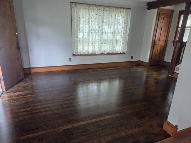 Newly finished livingroom floor, closet on right, and side porch on left - 2412 E Ohio Ave