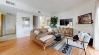 Located at 17621 W Pauline Ct in Santa Clarita, CA, this well-appointed two-story home offers 3 bedrooms and 3 bathrooms across two thoughtfully laid-out floors. The main level features warm hardwood flooring throughout a welcoming living room complete with a classic fireplace and sliding glass door that opens to an outdoor balcony, filling the space with natural light. Adjacent to the living room, the dining area is bathed in sunlight from multiple windows framed by sheer curtains, offering a bright and airy setting. The kitchen is equipped with warm maple cabinetry, granite countertops, stainless steel appliances including a gas range, microwave, and refrigerator, and a peninsula with bar seating — ideal for casual meals. Upstairs, the primary bedroom is a comfortable retreat featuring plush carpeting, a statement headboard wall, a sliding glass door, and direct access to a vanity area. Additional bedrooms are generously sized with soft carpeting and convenient access to well-appointed bathrooms. Each bathroom features tile flooring, warm wood vanities, and clean, neutral finishes. Crown molding and recessed lighting add refined architectural details throughout, while the overall neutral palette creates a cohesive and inviting atmosphere across every room.