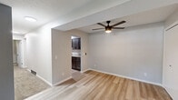 Located at 55 Grant St in Painesville, Ohio, this 2-bedroom, 1-bathroom unit offers a thoughtfully arranged single-floor layout. The living room welcomes you with light-toned luxury vinyl plank flooring, neutral gray walls, and a modern ceiling fan with integrated lighting. An open passageway connects the living area directly to the kitchen, creating a cohesive flow throughout the common spaces. The hallway entry features additional closet access and a clean, minimal aesthetic that carries throughout the home.

The galley-style kitchen is a standout feature, appointed with dark espresso shaker cabinets, granite-look countertops, a stainless steel double-basin sink, and black stainless appliances including a refrigerator and range. Bright overhead lighting enhances functionality in this well-organized cooking space.

The primary bedroom is finished with luxury vinyl plank flooring, neutral tones, and a window offering natural light and outdoor views. The second bedroom features plush carpeting, a textured ceiling, and its own window. A dedicated closet with built-in shelving and rod provides ample storage. The full bathroom includes a tub-shower combination with chrome fixtures. Carpet flooring in the bedrooms and closet adds warmth throughout the private areas of this efficiently designed home.