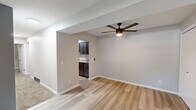 Located at 55 Grant St in Painesville, Ohio, this 2-bedroom, 1-bathroom unit offers a thoughtfully arranged single-floor layout. The living room welcomes you with light-toned luxury vinyl plank flooring, neutral gray walls, and a modern ceiling fan with integrated lighting. An open passageway connects the living area directly to the kitchen, creating a cohesive flow throughout the common spaces. The hallway entry features additional closet access and a clean, minimal aesthetic that carries throughout the home.

The galley-style kitchen is a standout feature, appointed with dark espresso shaker cabinets, granite-look countertops, a stainless steel double-basin sink, and black stainless appliances including a refrigerator and range. Bright overhead lighting enhances functionality in this well-organized cooking space.

The primary bedroom is finished with luxury vinyl plank flooring, neutral tones, and a window offering natural light and outdoor views. The second bedroom features plush carpeting, a textured ceiling, and its own window. A dedicated closet with built-in shelving and rod provides ample storage. The full bathroom includes a tub-shower combination with chrome fixtures. Carpet flooring in the bedrooms and closet adds warmth throughout the private areas of this efficiently designed home.