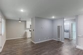 Located at 902 W Remington Dr in Sunnyvale, CA, this single-story 2-bedroom, 1-bathroom home offers a thoughtfully laid-out floor plan across one level. The living room serves as the heart of the home, anchored by a striking white brick fireplace and finished with wood-look flooring that extends throughout the main living areas. Large windows flank the front entry, filling the dining and living spaces with natural light and creating a bright, open ambiance.

The kitchen has been updated with crisp white shaker-style cabinetry, quartz countertops, and a full suite of stainless steel appliances including a range, microwave, and dishwasher. A dedicated laundry area is conveniently accessible from the main living space.

Both bedrooms are carpeted and feature neutral gray walls and window blinds. The primary bedroom includes mirrored sliding closet doors, adding a sense of depth to the room. The bathroom is clean and functional, equipped with a shower/tub combo featuring a handheld showerhead and a safety grab bar. Three closets throughout the home provide ample storage. The overall palette of soft grays and whites lends the space a clean, modern feel well-suited for everyday living in the heart of Silicon Valley.
