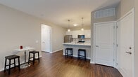 Located in Columbus, OH, this 2-bedroom, 1-bathroom unit offers a thoughtfully designed single-floor layout that maximizes functionality and comfort. The open-concept living and kitchen area serves as the heart of the home, featuring rich dark hardwood-style flooring and a seamless flow between spaces. The kitchen is well-equipped with stainless steel appliances, including a refrigerator, range, and microwave, all complemented by crisp white cabinetry and striking marble-look countertops. A peninsula with bar seating and pendant lighting above adds both style and practicality, making it ideal for casual dining or entertaining. The living area benefits from natural light streaming through large windows fitted with blinds. Both bedrooms are carpeted for comfort and include generous windows that bring in natural light. The primary bedroom is a comfortable retreat with access to a well-organized closet featuring wire shelving. A second closet provides additional storage. The full bathroom is finished with a marble-look vanity countertop, white cabinetry, a large mirror, and a shower-tub combination. Neutral warm-toned walls throughout create a cohesive and inviting atmosphere across every room in this efficiently designed Columbus residence.