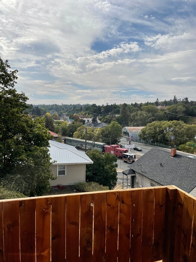 Daytime view of train cars - 140 NE Whitman St