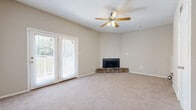 This single-floor, two-bedroom, one-bathroom residence at Valley Station Apartments in Birmingham, Alabama offers a well-organized layout with neutral tones and carpeted living areas throughout. The living room serves as the central gathering space, highlighted by a stone-surround corner fireplace, a ceiling fan with integrated lighting, and French doors that open to an outdoor patio, allowing natural light to flow into the room. Adjacent to the living area, a raised step leads into a secondary space that could serve as a dining area, illuminated by a pendant light fixture.

The galley-style kitchen features white shaker cabinetry, granite-look countertops, wood-look flooring, track lighting, and black appliances including a range, refrigerator, and dishwasher. Both bedrooms are generously proportioned, carpeted, and receive natural light through blinded windows. One bedroom includes a walk-in closet, while the other offers a standard closet with louvered doors.

The bathroom is finished with a white vanity, granite-look countertop, a framed mirror with a lighted vanity bar, a tiled tub-shower combination, and wood-look flooring, presenting a clean, cohesive aesthetic throughout.