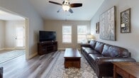 Located at 3011 Pisgah Rd in Florence, South Carolina, this well-appointed single-story home offers a cohesive and comfortable layout throughout. Wood-look luxury vinyl plank flooring runs consistently across the entire floor plan, providing a warm, unified aesthetic in every room.

The galley-style kitchen is a functional highlight, featuring rich dark cabinetry, granite countertops, stainless steel appliances including a refrigerator, electric range, built-in microwave, and dishwasher, along with a window that brings in natural light.

The open living area is bright and inviting, with vaulted ceilings, ceiling fans, and multiple windows allowing ample natural light. A cozy sitting nook with dual windows offers a pleasant retreat within the main living space.

The primary bedroom features a tray ceiling with a ceiling fan, adding architectural interest, while a second bedroom provides comfortable accommodations with its own window and natural light.

A full bathroom includes a walk-in shower, dark cabinetry with granite countertops, and black hardware accents. The dedicated laundry room is equipped with a full-size washer and dryer and built-in shelving for added storage. A central hallway connects all areas of the home, contributing to its efficient and practical single-floor design.