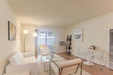 Located at 1032 W Remington Ave in Sunnyvale, CA, this well-designed 2-bedroom, 1-bathroom single-floor home offers a comfortable and efficient layout. Warm hardwood flooring flows throughout, lending a cohesive and inviting feel to the entire space.

The combined living and dining area serves as the heart of the home, bathed in natural light from a sliding glass door that opens directly onto a private patio — ideal for outdoor relaxation. The open layout comfortably accommodates both lounging and dining areas, creating a versatile space for everyday living.

The kitchen is thoughtfully arranged with warm wood cabinetry, white countertops, and stainless steel appliances, including a range, over-the-range microwave, and refrigerator. A window above the sink brings in natural light, enhancing the functionality of the space.

Both bedrooms are quietly situated off a connecting hallway and feature hardwood floors, neutral walls, and mirrored sliding closet doors that reflect light and add a sense of depth. Three closets throughout the home provide ample storage.

The bathroom is clean and well-appointed, featuring a tub/shower combo with frosted glass sliding doors, a vanity with white cabinetry, and hardwood flooring. A hallway connects all rooms, ensuring a practical and smooth flow throughout this charming Sunnyvale home.