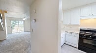 Located at 2950 W Portage Bay Ave in Davis, CA, this two-story home offers 2 bedrooms and 4 bathrooms thoughtfully distributed across two levels. The main floor features a combined kitchen and living area, where an open-concept kitchen showcases a large quartz peninsula with an integrated sink, white cabinetry, and black appliances, including a full-size refrigerator and range. The living room is bright and welcoming, with plush carpet, a ceiling fan, and a sliding glass door that opens to a balcony with outdoor views of the surrounding landscape. A staircase with a sleek metal railing connects the two floors. The upper level houses both bedrooms, each carpeted and equipped with wide sliding panel closets offering generous storage. The primary bedroom includes a ceiling fan and ample square footage. The four bathrooms are finished in a clean, neutral palette with light wood-style flooring, white vanities with beige countertops, and chrome fixtures. Several bathrooms feature separate water closets for added privacy. Throughout the home, warm beige tones and abundant natural light from multiple windows create a comfortable, functional living environment.