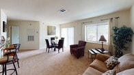 Located at 1205 Christiana Meadows in Bear, Delaware, this single-floor residence offers a thoughtfully designed layout that balances comfort and practicality. The open-concept living and dining area is bright and welcoming, featuring large windows that invite natural light and views of the surrounding neighborhood. The carpeted living space accommodates both a seating area and a dining set positioned near sliding glass doors, enhancing the sense of openness.

The kitchen is efficiently laid out with warm oak cabinetry, dark laminate countertops, tile flooring, and a full suite of appliances including a range, refrigerator, and dishwasher. A breakfast bar with seating connects the kitchen to the adjacent living area. Notably, an in-unit laundry closet with a washer and dryer is conveniently situated just off the kitchen.

The residence includes multiple bedrooms, each carpeted and featuring windows with natural light. The primary bedroom is generously proportioned with ample floor space, while the secondary bedroom offers a comfortable and cozy atmosphere. Both bathrooms are well-appointed with tub-shower combinations, tile flooring, and wood-toned vanity cabinetry. Throughout the home, neutral tones and consistent finishes create a cohesive and functional living environment.