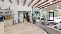Located at 650 W Rand Rd in Arlington Heights, IL, this single-floor amenity space offers a thoughtfully designed environment spanning a generous footprint. The centerpiece is an expansive open lounge area distinguished by striking exposed wood ceiling beams, pendant lighting, and light hardwood flooring. A floor-to-ceiling tiled fireplace anchors the living area, complemented by large glass doors that invite natural light and offer views of the outdoor pool area, creating a seamless indoor-outdoor connection.

The fitness facilities are divided into two dedicated spaces: a fully equipped cardio and strength gym featuring modern treadmills, a stair climber, wall-mounted TVs, and sleek acoustic wall paneling, alongside a spacious yoga and movement studio with large windows overlooking the exterior grounds and open carpeted floors ideal for group classes or individual workouts.

Three private offices provide functional workspaces, each outfitted with contemporary light wood desks, modern lighting, and carpet flooring. The main leasing office reception area features a moss wall art installation and glass-partitioned conference rooms for private meetings. A cozy breakout nook with a round table offers additional collaborative space. A media room and closet round out the well-appointed layout, making this a versatile and polished community amenity hub.