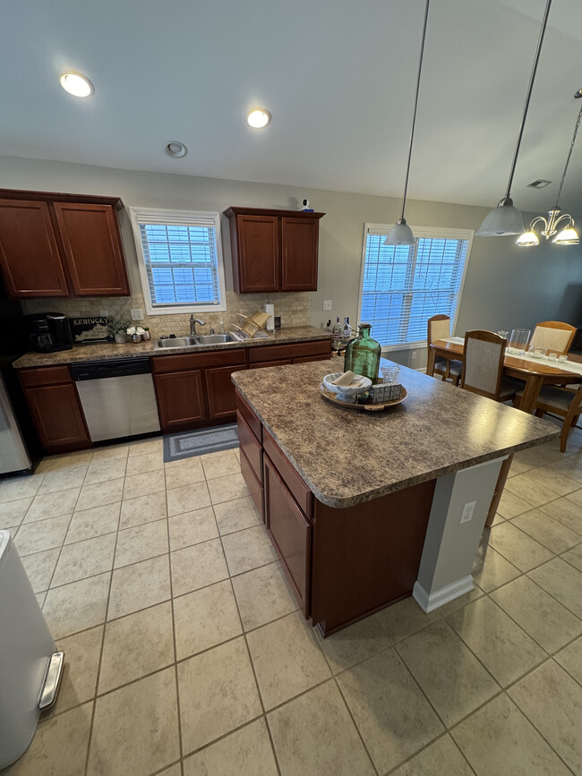 Kitchen (view 2) with island and bar seating. - 4128 Katherine Pl