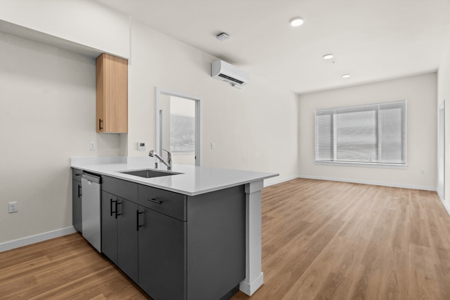 Enjoy seamless living and entertaining with an open-concept layout, modern finishes, and abundant natural light. - 27 West Apartments