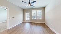 Located at 640 Lakeside Dr in Canton, GA, this well-appointed 1-bedroom, 1-bathroom residence offers a thoughtfully designed single-level layout with modern finishes throughout. The open-concept kitchen and living area serves as the heart of the home, showcasing crisp white shaker cabinetry, a marble-look tile backsplash, stainless steel appliances, and a central island with a black matte sink fixture and white quartz countertops — ideal for both cooking and casual entertaining. Light hardwood-style flooring runs throughout the main living areas, adding warmth and continuity to the space. The living room is bright and airy, benefiting from natural light through large windows and direct balcony access via a glass-panel door, with a ceiling fan overhead. The bedroom is generously sized, featuring plush carpeting, a ceiling fan, and a window with views of the surrounding community. The bathroom is finished with white cabinetry, quartz countertops, and matte black hardware, maintaining a clean and contemporary aesthetic. A dedicated laundry room houses a full-size front-loading washer and dryer set with overhead wire shelving for added storage. The overall design is clean, modern, and move-in ready.