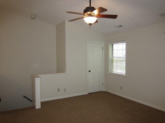 Second floor stairway, entry into Living Room. Freshly painted and new carpet throughout. - 8937 Cardinal Ter