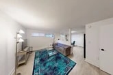 Located at 1817 Burnet Ave in Syracuse, NY, this efficient and thoughtfully designed 1-bedroom, 2-bathroom unit offers a comfortable, modern living experience across a single floor. The open-concept living area is defined by light wood laminate flooring, crisp white walls, and a distinctive lattice-style room divider that visually separates the living space from the adjoining dining and kitchen area while maintaining an airy, connected feel. Horizontal windows allow natural light to filter in, brightening the interior throughout the day. The kitchen is well-equipped, featuring rich cherry wood cabinetry, granite-style countertops, a tiled backsplash, and a full suite of black appliances including a gas range, dishwasher, and refrigerator, along with an over-the-range microwave. The bedroom offers a quiet retreat with two windows, light wood flooring, a mirrored sliding closet, and ample space for a desk and sleeping area. Clean white walls and neutral tones carry throughout the space, giving it a fresh, move-in-ready appearance. Two bathrooms provide added convenience, and a dedicated hallway with built-in storage adds to the unit's practicality. The overall ambiance is clean, modern, and efficiently organized.