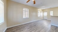 Located at 252 N Lauderdale St in Memphis, TN, this two-bedroom, two-bathroom unit offers a practical and well-appointed single-story layout. Throughout the home, durable luxury vinyl plank flooring in a warm gray tone provides a cohesive and easy-to-maintain foundation.

The open living area is bright and welcoming, featuring multiple windows with blinds that invite natural light, a ceiling fan with a light fixture, and warm beige walls that create a clean, neutral palette. The space flows seamlessly toward the kitchen, which is separated by a peninsula-style counter. The kitchen is well-equipped with light wood cabinetry, black appliances including a refrigerator, range, microwave, and dishwasher, a single-basin sink, and a skylight-style overhead fixture that keeps the space well-lit.

The primary bedroom is a comfortable size and includes access to a closet as well as an en-suite bathroom. Both bathrooms feature tub-shower combinations, wood-toned vanity cabinetry, and the same LVP flooring found throughout the unit. The second bedroom also benefits from a window with natural light. A dedicated walk-in closet with wire shelving provides generous storage. Ceiling fans are present in the main living area and primary bedroom, enhancing everyday comfort throughout this efficiently designed home.