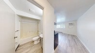 Located at 184 Remington Ave in Syracuse, NY, this one-bedroom, one-bathroom unit offers a well-organized, single-floor layout designed to maximize functionality. Light wood-style vinyl flooring runs throughout the entire space, creating a cohesive and bright aesthetic complemented by crisp white walls.

The kitchen is a standout feature, equipped with stainless steel appliances including an electric range and a full-size refrigerator. White shaker-style cabinetry pairs with a classic white subway tile backsplash, offering clean lines and ample storage. A single-basin sink with a modern faucet and under-counter cabinetry complete the practical setup, with ceiling-mounted lighting providing even illumination.

The bedroom is a comfortable, well-proportioned room featuring a window with blinds that allows for natural light and outdoor views of the surrounding neighborhood. A baseboard heating unit ensures warmth, and the room's clean, neutral walls offer a versatile canvas for personalization.

The bathroom is efficiently laid out, featuring a full tub-shower combination, toilet, and vanity sink with under-sink storage. Wood-style flooring extends here as well, maintaining design consistency throughout the unit.

Overall, the space presents a clean, updated interior with a neutral palette, making it a practical and move-in-ready option in the Syracuse area.