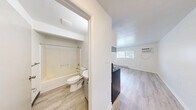Located at 184 Remington Ave in Syracuse, NY, this one-bedroom, one-bathroom unit offers a well-organized, single-floor layout designed to maximize functionality. Light wood-style vinyl flooring runs throughout the entire space, creating a cohesive and bright aesthetic complemented by crisp white walls.

The kitchen is a standout feature, equipped with stainless steel appliances including an electric range and a full-size refrigerator. White shaker-style cabinetry pairs with a classic white subway tile backsplash, offering clean lines and ample storage. A single-basin sink with a modern faucet and under-counter cabinetry complete the practical setup, with ceiling-mounted lighting providing even illumination.

The bedroom is a comfortable, well-proportioned room featuring a window with blinds that allows for natural light and outdoor views of the surrounding neighborhood. A baseboard heating unit ensures warmth, and the room's clean, neutral walls offer a versatile canvas for personalization.

The bathroom is efficiently laid out, featuring a full tub-shower combination, toilet, and vanity sink with under-sink storage. Wood-style flooring extends here as well, maintaining design consistency throughout the unit.

Overall, the space presents a clean, updated interior with a neutral palette, making it a practical and move-in-ready option in the Syracuse area.