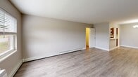 Located at 1808 Kuser Rd in Trenton, NJ, this single-floor residence offers a practical and well-designed layout. The open-concept living, dining, and kitchen area forms the heart of the unit, creating a connected and functional living space. The living area features light-toned luxury vinyl plank flooring, neutral gray walls, and large windows fitted with blinds that allow natural light to fill the room. A wall-mounted air conditioning unit and baseboard heating ensure year-round comfort. The front entry door, accented with glass panel inserts, adds a welcoming touch.

The kitchen is outfitted with dark espresso-toned shaker-style cabinetry, white quartz countertops, and a gray tile backsplash. Stainless steel appliances, including a refrigerator, dishwasher, and additional appliances, provide a modern and cohesive aesthetic. A window above the sink brings in natural light. The dining area transitions seamlessly from the kitchen, illuminated by a multi-arm chandelier.

The generously sized primary bedroom features the same vinyl plank flooring, neutral tones, and windows with outdoor views. Three closets throughout the unit offer ample storage. The overall design is clean, modern, and move-in ready.