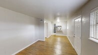 Located at 403 Garner Rd in Pasadena, TX, this single-story, 2-bedroom, 1-bathroom home offers a clean and functional layout with consistent, modern finishes throughout. The living room welcomes you with warm hardwood-style flooring, neutral gray walls, and a window that lets in natural light, creating a bright and inviting atmosphere. Both bedrooms continue the hardwood-style flooring and are equipped with ceiling fans for added comfort. The primary bedroom offers ample space, a closet with paneled doors, and a window overlooking the greenery outside. The second bedroom also features a ceiling fan and a window with outdoor views. The kitchen is efficiently designed with gray cabinetry, granite-style countertops, a stainless steel sink, and black appliances including a refrigerator and electric range. Light tile flooring and a window provide a practical and pleasant cooking environment. The bathroom is neatly finished with a gray vanity, granite-style countertop, a framed mirror, tile flooring, and a shower-tub combination. A hallway connects the rooms, contributing to the home's cohesive and easy-to-navigate floor plan. The overall aesthetic is clean, neutral, and move-in ready.