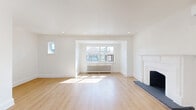 Located at 1214 Avenue Rd, Unit 3 in Toronto's sought-after Avenue Road corridor, this well-appointed 2-bedroom, 1-bathroom unit offers a thoughtfully designed single-floor layout. The expansive living area is divided into two connected zones by a striking arched doorway, lending an elegant architectural character to the space. Light hardwood flooring flows throughout, complementing the crisp white walls and recessed lighting. A classic white fireplace with a decorative mantel serves as a focal point, while a ductless mini-split unit and traditional cast-iron radiators provide climate control year-round. Large windows allow abundant natural light to fill the space. The modern kitchen features white shaker-style lower cabinets, light wood upper cabinetry, white quartz countertops, a black hardware accents, a double undermount sink, and stainless steel appliances. The bathroom is finished with a wood-toned vanity, dark countertop, arched mirror, and tiled flooring. Both bedrooms are bright and comfortable, each with radiator heating and hardwood floors. A dedicated laundry room with washer and dryer adds everyday convenience. A covered private balcony with wood detailing and neighbourhood views completes this well-rounded unit.