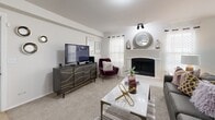 Located at 1551 W 78th St S in Tulsa, Oklahoma, this thoughtfully designed single-story residence offers 1 bedroom and 2 bathrooms within a comfortable and efficient floor plan. The open-concept living and dining area serves as the heart of the home, anchored by a white-surround wood-burning fireplace flanked by windows dressed in sheer curtains and plantation shutters, filling the space with natural light. Soft carpeting flows throughout the living, dining, and bedroom areas, contributing to a warm and cohesive feel. The dining area features chair-rail molding and additional windows, offering a bright and inviting setting. The kitchen is outfitted with white upper cabinetry, gray lower cabinetry, a classic subway tile backsplash, stainless steel appliances, and a spacious white-countertop island with bar seating—ideal for both cooking and casual dining. A walk-in pantry adds valuable storage. The generously sized primary bedroom features a ceiling fan, plush carpeting, and access to a well-appointed en suite bathroom complete with a soaking tub, gray vanity cabinetry, and tile flooring. Two closets provide ample storage throughout the home. The layout is completed by a hallway connecting each functional space seamlessly.