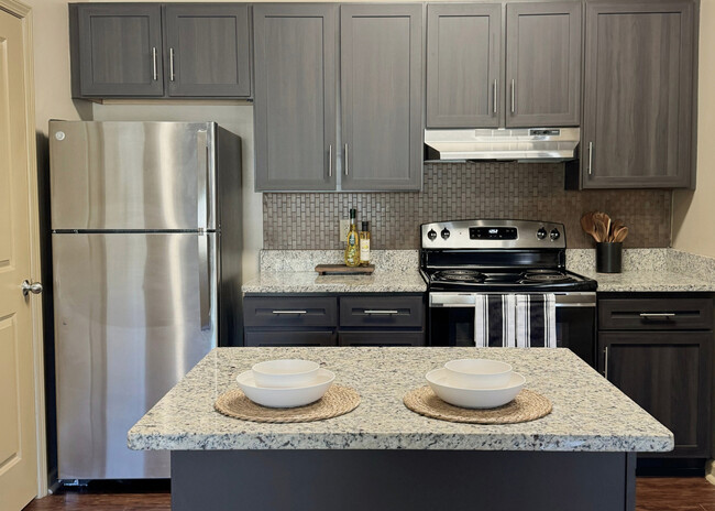 Large Kitchen Island with Espresso Cabinets, Granite Countertops, and Stainless Steel Appliances - Eagle's Brooke