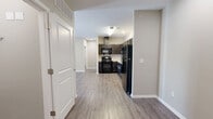 Located at 5700 Bruns Dr in Louisville, KY, this single-floor, 2-bedroom, 2-bathroom residence offers a practical and comfortable layout designed for everyday living. The open-concept living and dining area flows naturally from the kitchen, featuring durable wood-look luxury vinyl plank flooring that extends throughout the common spaces, creating a cohesive and easy-to-maintain environment. Recessed lighting and neutral-toned walls contribute to a clean, modern ambiance throughout.

The kitchen is well-equipped with dark espresso cabinetry, light stone countertops, and black appliances including a refrigerator, dishwasher, and range. Ample upper and lower cabinet storage makes this kitchen as functional as it is attractive.

Both bedrooms are carpeted for comfort and each features a ceiling fan with light fixture and a window that allows natural light to fill the space. The primary bedroom is generously sized and includes access to a dedicated bathroom with a single-sink vanity and a tub-shower combination. The second bathroom offers a walk-in shower stall with a clean, all-white surround and matching dark cabinetry with stone countertops. A dedicated closet provides additional storage within the unit.