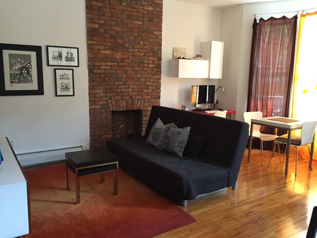 Open concept kitchen and living room. Decorative fireplace. - 233 Greene Ave