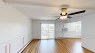 Located at 2517 Ravenwood Ct in Crescent Springs, KY, this one-bedroom, one-bathroom unit offers a thoughtfully arranged single-floor layout. Warm hardwood-style flooring runs throughout the entire space, creating a cohesive and inviting aesthetic in every room.

The living room is a bright, open area highlighted by elegant wainscoting along the lower walls, a ceiling fan with integrated lighting, and sliding glass doors that lead to a private balcony, filling the room with natural light and outdoor views. Baseboard heating and a wall-unit air conditioner provide year-round climate control.

The kitchen features white shaker-style cabinetry with matte black hardware, a light countertop, a single-basin sink, and a full suite of stainless steel appliances including a range, over-the-range microwave, and dishwasher.

The bedroom is a comfortable, well-proportioned room with a ceiling fan, wainscoting accents, and a reach-in closet with built-in shelving. An additional closet provides further storage.

The bathroom is finished with crisp white subway tile surrounding a tub/shower combination, complemented by sleek matte black fixtures, delivering a clean, modern look throughout.