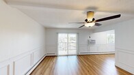 Located at 2517 Ravenwood Ct in Crescent Springs, KY, this one-bedroom, one-bathroom unit offers a thoughtfully arranged single-floor layout. Warm hardwood-style flooring runs throughout the entire space, creating a cohesive and inviting aesthetic in every room.

The living room is a bright, open area highlighted by elegant wainscoting along the lower walls, a ceiling fan with integrated lighting, and sliding glass doors that lead to a private balcony, filling the room with natural light and outdoor views. Baseboard heating and a wall-unit air conditioner provide year-round climate control.

The kitchen features white shaker-style cabinetry with matte black hardware, a light countertop, a single-basin sink, and a full suite of stainless steel appliances including a range, over-the-range microwave, and dishwasher.

The bedroom is a comfortable, well-proportioned room with a ceiling fan, wainscoting accents, and a reach-in closet with built-in shelving. An additional closet provides further storage.

The bathroom is finished with crisp white subway tile surrounding a tub/shower combination, complemented by sleek matte black fixtures, delivering a clean, modern look throughout.