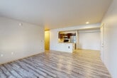 Located at 13004 Meridian Ave S in Everett, WA, this thoughtfully designed unit offers four bedrooms and two bathrooms across a single floor. Light wood-style flooring runs throughout, lending a clean and cohesive aesthetic to the entire space. The open-concept living and dining area is generously proportioned, filled with natural light, and features a sliding glass door leading to a private balcony with outdoor views. The kitchen is efficiently laid out with dark upper cabinetry, light countertops, a peninsula with a sink, and a full suite of stainless steel appliances including a refrigerator, range, microwave, and dishwasher. A hallway connects the living area to the four bedrooms, each of which is well-sized with large windows that bring in natural light and views of the surrounding neighborhood. The primary bedroom includes a dedicated walk-in closet outfitted with wire shelving for organized storage. Both bathrooms are finished with dark vanity cabinetry, light countertops, framed mirrors, and a tub-shower combination. The overall design is modern and functional, offering a comfortable and practical layout suited for a variety of living arrangements.