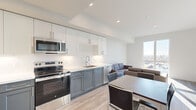 Located at 2077 Haste Street in Berkeley, CA, this well-designed single-floor residence offers three bedrooms, two bathrooms, and a thoughtfully laid-out open-concept living area. The kitchen is a standout feature, showcasing two-tone cabinetry with white upper cabinets and slate-blue lower cabinets, a white tile backsplash, stainless steel appliances including a refrigerator, range, microwave, and dishwasher, and light wood-style flooring that extends seamlessly into the living and dining area. The living room is bright and comfortable, with large windows that invite generous natural light and provide views of the surrounding Berkeley neighborhood. Each bedroom features plush carpeting, wall-mounted mini-split HVAC units, and large windows that frame outdoor views, creating airy and well-lit personal spaces. The spacious primary bedroom offers an especially open feel. Both bathrooms are finished in a clean, modern style with wood-look tile flooring, white vanities, and shower-tub combinations. Throughout the residence, the design maintains a cohesive, contemporary aesthetic with neutral tones, clean lines, and practical finishes suited for everyday living in the heart of Berkeley.
