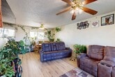 Located at 150 Miguel St in Ridgecrest, CA, this two-story, 3-bedroom, 2-bathroom home offers a practical and comfortable layout across two floors. The main level houses the combined living room, dining room, and kitchen — an open-concept arrangement that maximizes the modestly scaled footprint. The living area features light wood flooring, a textured ceiling, and a ceiling fan, lending a relaxed, airy feel. The kitchen is equipped with warm oak cabinetry, ample counter space, a dishwasher, and a window that brings in natural light. The adjacent dining area includes a window overlooking the exterior, creating a bright spot for meals. The upper floor, which comprises the majority of the home's total area, contains all three bedrooms, two hallways, and both bathrooms. Each bedroom includes a ceiling fan and mirrored sliding closet doors. The primary bedroom offers a comfortable sense of space. The bathrooms feature wood-toned vanity cabinetry and light wood flooring. A standout feature of the upper level is a sliding glass door that opens to a balcony with outdoor views. With four closets distributed throughout, storage is well accounted for. The home is connected between floors via two staircases, ensuring convenient circulation throughout.