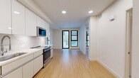 Located at 1641 Lincoln Blvd, Unit 1-208, in Santa Monica, CA, this modern 2-bedroom, 2-bathroom apartment offers 600 square feet of thoughtfully designed living space on a single floor. The unit features consistent light wood flooring throughout the main living areas, creating a warm and cohesive aesthetic against the crisp white walls and clean-lined architecture.

The primary bedroom, at 360 square feet, is spacious and bright, equipped with a ceiling fan and a sliding closet. The second bedroom also benefits from natural light via large black-framed floor-to-ceiling windows that overlook an exterior courtyard, adding an airy, open feel to the space.

The kitchen is outfitted with sleek white cabinetry, marble-look tile backsplash, stainless steel appliances including a range and microwave, and a sink with ample counter space — reflecting a modern, functional design sensibility.

A dedicated laundry closet houses a stacked full-size washer and dryer unit, conveniently positioned near the kitchen. The bathroom features hexagonal marble-patterned tile flooring, a full soaking tub with shower combination, and clean white tile surround. The overall ambiance of the unit is bright, minimalist, and well-appointed, making it an ideal residence in the heart of Santa Monica.