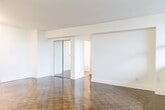 Located at 1249 N Shore Blvd E in Burlington, Ontario, this one-bedroom, one-bathroom unit offers a well-organized layout across a single floor. The living room is a standout feature, boasting a wall of large panoramic windows that flood the space with natural light while framing elevated views of the surrounding Burlington cityscape and greenery. Rich, polished parquet wood flooring runs throughout the main living areas and bedroom, adding warmth and character to the space. Baseboard heating runs along the window walls, ensuring comfort throughout the seasons. The kitchen is clean and functional, featuring white shaker-style cabinetry, a white subway tile backsplash, dark stone-effect countertops, and a double stainless steel sink with a modern pull-down faucet. The bedroom is a comfortable, well-proportioned room with its own large window offering pleasant outdoor views, parquet flooring, and a sliding closet door for convenient storage. The bathroom is finished with white subway tile from floor to ceiling, a soaker tub with an overhead shower, and a small frosted window for ventilation. The overall aesthetic is clean, bright, and move-in ready.