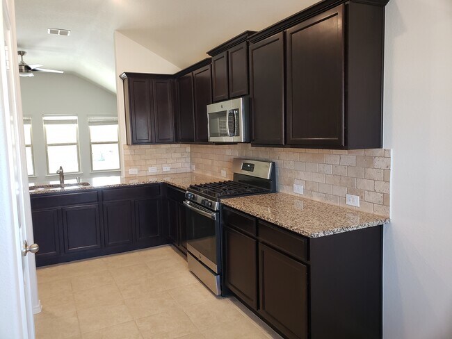 Dark cabinets with pantry and lots of storage. - 14557 Serrano Ridge Rd