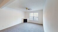 Located at 9005 Pegasus Pointe Dr in Louisville, KY, this single-floor residence offers a practical and well-maintained layout designed for comfortable everyday living. The home's interior is finished with a neutral color palette throughout, creating a clean and versatile backdrop.

The living area is a notable highlight, featuring plush carpeting, a textured ceiling, a ceiling fan, and a fireplace framed by a light-toned surround. A large window allows natural light to fill the room, contributing to an open and welcoming ambiance. The entryway transitions seamlessly from wood-look plank flooring near the front door into the carpeted living space.

The kitchen is well-equipped with warm-toned wooden cabinetry providing generous storage above and below the counters. It includes a double-basin sink, a coil-element range, a dishwasher, and wood-look flooring that ties the space together cohesively.

The bedrooms are carpeted and include ceiling fans and windows for natural light. Closets with built-in hanging rods provide practical storage solutions in the sleeping areas.

The bathroom features wood-look flooring, a combination tub and shower with a curtain rod, a toilet, and a vanity with warm wood cabinetry and a light-toned countertop. Overall, the home presents a functional and tidy living environment.