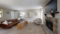 This well-designed three-bedroom, four-bathroom apartment in Peachtree Corners, GA offers a thoughtful single-floor layout with a generous amount of living space. The open-concept kitchen and living area serves as the heart of the home, featuring white cabinetry, granite-style countertops, wood-look flooring, and a full suite of black appliances including a refrigerator, range, microwave, and dishwasher. The adjacent living room is warm and inviting, highlighted by a stone fireplace, plush carpeting, and large windows that allow ample natural light to fill the space. A dedicated laundry area includes a full-size washer and dryer. The spacious primary bedroom offers generous proportions, soft carpeting, natural light from large windows, and direct access to a private en-suite bathroom with granite-style vanity and tub/shower combination. Two additional bedrooms provide comfortable accommodations, each with their own access to well-appointed bathrooms featuring clean white tile and modern fixtures. Three closets are distributed throughout the unit for ample storage. Neutral tones and consistent finishes create a cohesive, move-in ready aesthetic throughout the entire home.