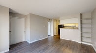 Located at 5915 Flintlock Road in Houston, TX, this one-bedroom, one-bathroom unit offers a practical and well-organized layout across a single floor. Wood-style flooring flows consistently throughout the space, lending a cohesive and clean aesthetic to every room.

The combined kitchen and living area forms the heart of the unit. The kitchen is outfitted with white cabinetry, granite-style countertops, a mosaic tile backsplash, and black appliances including a range, dishwasher, and refrigerator. The adjacent living area benefits from natural light through a large sliding glass door that opens to an outdoor space, creating an airy and open feel.

The bedroom is a comfortable, well-proportioned room featuring a ceiling fan with light fixture and a window with blinds that allows natural light while maintaining privacy. A dedicated closet provides built-in open shelving for organized storage.

The bathroom is straightforward and functional, equipped with a full-size tub and shower combination with white tile surround. A separate closet space within the unit adds further storage flexibility.

Neutral wall tones throughout create a calm, versatile backdrop suited to a variety of interior styles. The overall layout is efficient, making thoughtful use of the available space for comfortable everyday living.