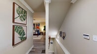 Located at 615 Fallview Lane in Boone, NC, this three-story, 5-bedroom, 5-bathroom home offers a well-organized layout across three distinct floors. The entry level welcomes guests with a bright foyer featuring wood-look flooring and a classic white-baluster staircase, setting a clean, welcoming tone throughout. The open-concept main living area seamlessly connects the living room, dining area, and kitchen. The living room is finished with crown molding, wood-look flooring, and a ceiling fan, while the kitchen stands out with white shaker-style cabinetry, dark granite countertops, stainless steel appliances, and a breakfast bar. Each of the five bedrooms is comfortably sized, with the primary bedroom offering a notably spacious footprint, plush carpet, and ceiling fan. The five bathrooms are consistently appointed with granite-topped vanities and tub-shower combinations. A dedicated laundry room, multiple utility spaces, ample closet storage throughout, and a balcony round out the home's practical amenities. The neutral warm-toned walls and consistent wood-look flooring on the main levels create a cohesive and inviting atmosphere, making this multi-story Boone home well-suited for comfortable group or family living.