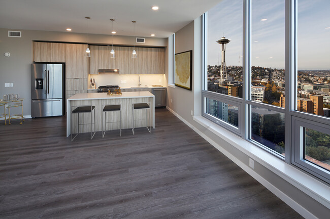 Signature Collection penthouse kitchen and dining area with hard surface flooring. - Avalon Belltown Towers