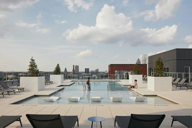 Experience luxury living with our breathtaking rooftop pool and sweeping cityscape views. - Inspire