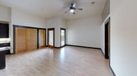 Located at 200 N 20th St in Richmond, VA, this 2-bedroom, 2-bathroom residence offers a thoughtfully designed single-floor layout with contemporary finishes throughout. Light hardwood flooring flows through the main living areas and bedrooms, complemented by bold dark baseboards and trim that create a clean, modern contrast.

The kitchen is a standout feature, showcasing dark espresso cabinetry, granite countertops, stainless steel appliances, and a peninsula with bar-top seating. Soaring ceilings with an exposed industrial duct add loft-like character to the space.

The primary bedroom is generously proportioned and features a ceiling fan, access to a patio via glass-paned doors, and a closet with louvered doors that allow natural light to filter in. The second bedroom is bright and airy with its own ceiling fan.

Both bathrooms feature large-format tile flooring, dark vanity cabinetry with granite countertops, and tub/shower combinations. One bathroom includes accessibility grab bars and a more open layout. The hallway connects all rooms efficiently, and a dedicated closet provides additional storage. A private patio rounds out the unit, offering outdoor space for residents.