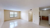 This two-bedroom, one-bathroom residence in Lexington, Kentucky offers a practical and efficient single-floor layout. The combined living and dining area serves as the heart of the home, featuring light-toned tile flooring that runs throughout the unit, neutral cream-colored walls, and a textured ceiling. A large window allows natural light to fill the space, creating a bright and open atmosphere.

The galley-style kitchen is well-equipped with warm oak cabinetry, dark laminate countertops, a white electric range, a refrigerator, and a dedicated sink area — providing ample storage and prep space in a compact, functional layout. The kitchen opens conveniently toward the hallway and main living areas.

Both bedrooms are comfortably sized with light tile flooring, neutral walls, and windows that invite natural light and outdoor views of the surrounding greenery. The primary bedroom offers a notably generous footprint. Notably, the unit features five closets distributed throughout, offering exceptional storage capacity for a residence of this size.

The full bathroom includes a shower/tub combination and tile flooring. A dedicated laundry area adds everyday convenience. The hallway connects all rooms efficiently, contributing to a cohesive and easy-to-navigate floor plan throughout this well-organized home.