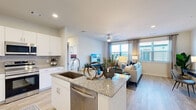 Located in Spring, TX, this well-appointed one-bedroom, one-bathroom residence offers a thoughtfully designed open-concept layout with modern finishes throughout. Light wood-style flooring flows seamlessly across the entire unit, creating a bright and cohesive aesthetic.

The kitchen is a standout feature, equipped with stainless steel appliances including a side-by-side refrigerator, range, microwave, and dishwasher. White shaker-style cabinetry pairs elegantly with granite countertops, while a central island with a deep undermount sink and bar seating provides both functionality and a natural gathering space. The kitchen opens directly into the living room, which is bathed in natural light from large windows dressed with neutral drapes. A ceiling fan adds comfort to the airy living area.

The bedroom is a comfortable retreat, featuring generous windows that invite natural light and an outdoor view, a ceiling fan, and a closet for ample storage. An additional room serves well as a home office or flex space, also benefiting from natural light.

The bathroom is clean and modern, featuring granite countertops, white cabinetry, a tub-shower combination with marble-style tile surround, and recessed lighting. Every room reflects a consistent, contemporary design sensibility that is both functional and inviting.