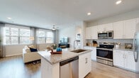 Located at 15255 FM-529 E in Houston, TX, this well-appointed single-floor residence offers a thoughtfully designed open-concept layout that seamlessly connects the kitchen, dining, and living areas. The kitchen is a standout feature, showcasing white shaker cabinetry, granite countertops, a subway tile backsplash, and a full suite of stainless steel appliances including a French door refrigerator, electric range, over-the-range microwave, and dishwasher. A central island with a built-in sink adds both functionality and visual appeal. Light wood-style flooring flows throughout the space, enhancing the bright, airy atmosphere. The living area is generously sized, bathed in natural light through large windows fitted with plantation shutters and sheer curtains, and includes a ceiling fan overhead. The bedrooms are comfortable and well-lit, each featuring windows with outdoor views and ceiling fans for added comfort. The bathroom is finished with granite-topped white vanity cabinetry, wood-style flooring, and a tub-shower combination with elegant marble-style tile surround. A spacious walk-in closet with wire shelving and hanging rods provides ample storage. The overall design is clean, modern, and cohesive throughout.